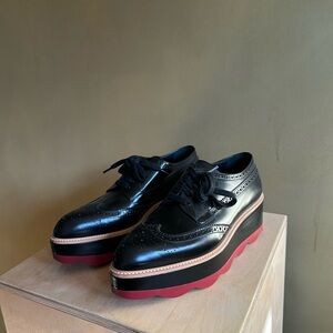 Prada Black Platform Wingtip Oxfords with Red Sole
